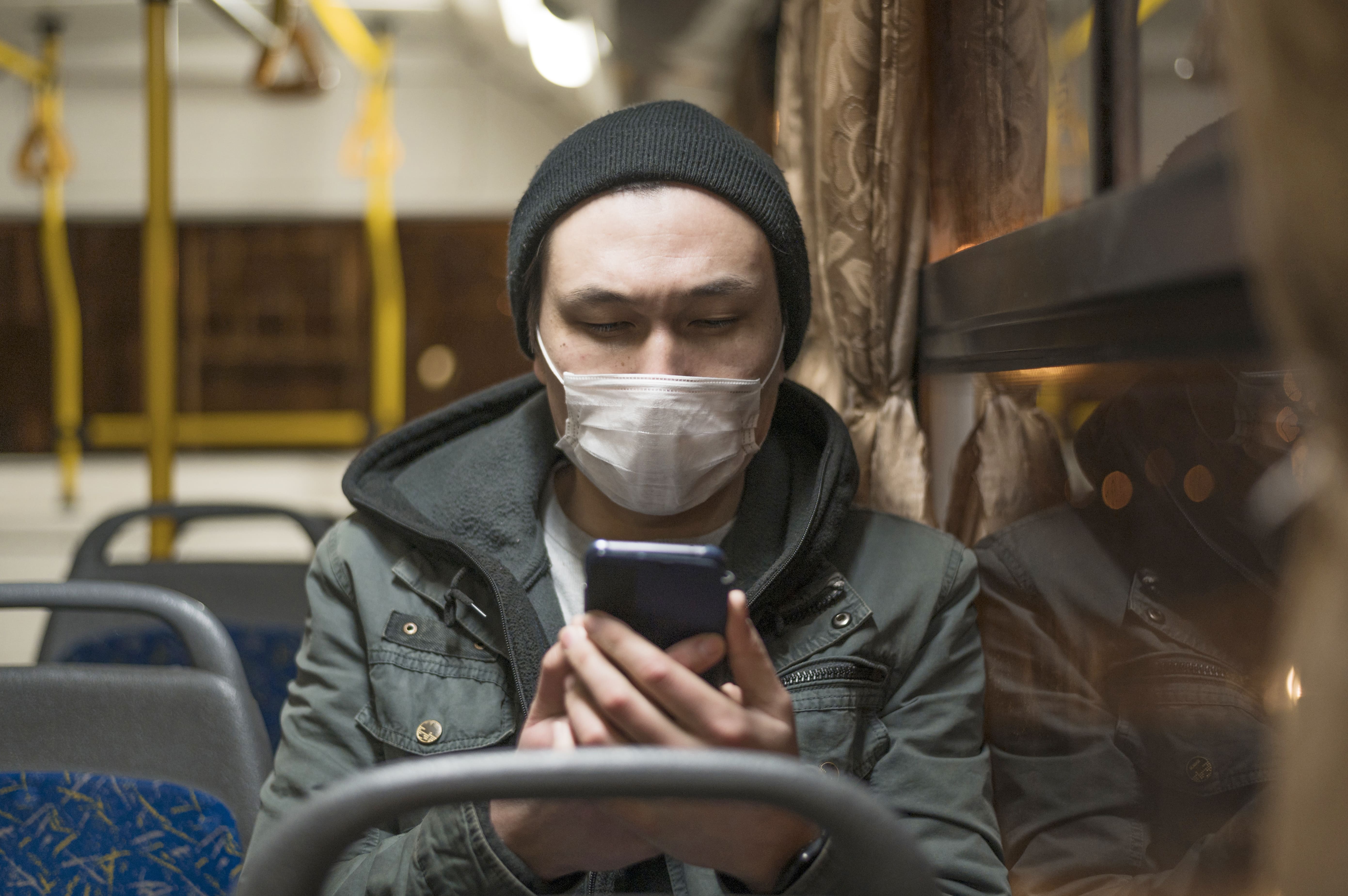 front-view-man-with-medical-mask-bus-looking-his-phone (1).jpg